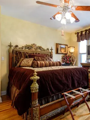 a bedroom with a large bed with a wooden headboard at Gaslight Bed & Breakfast in Cincinnati