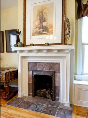 a fireplace in a living room with a picture above it at Gaslight Bed & Breakfast in Cincinnati