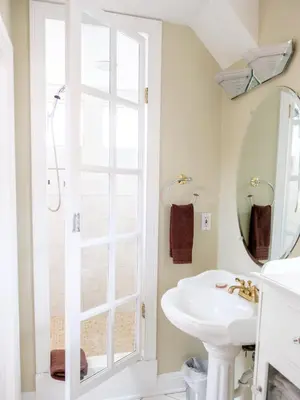 a white bathroom with a sink and a mirror at Gaslight Bed & Breakfast in Cincinnati