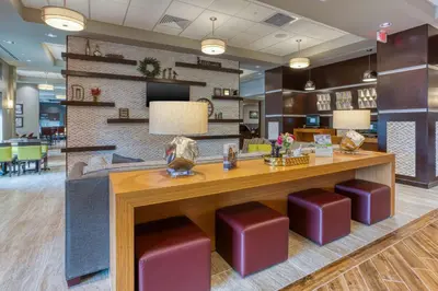 a lobby with a reception desk and purple stools at Drury Inn & Suites Cincinnati Northeast Mason in Mason