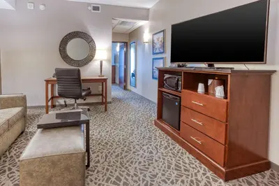 a living room with a large flat screen tv at Drury Inn & Suites Cincinnati Northeast Mason in Mason