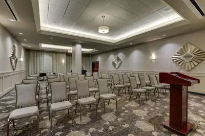 a room with rows of chairs and a podium at Drury Inn & Suites Cincinnati Northeast Mason in Mason