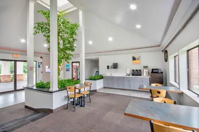 a classroom with tables and chairs and a kitchen at Motel 6 - Georgetown, KY - Lexington North in Georgetown