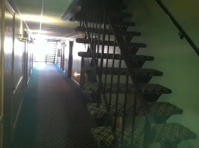 a hallway with a spiral staircase in a building at Heritage Inn Mansfield in Mansfield
