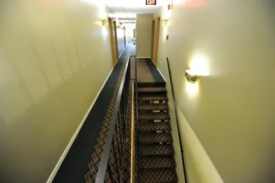 an empty hallway with stairs in a building at Heritage Inn Mansfield in Mansfield