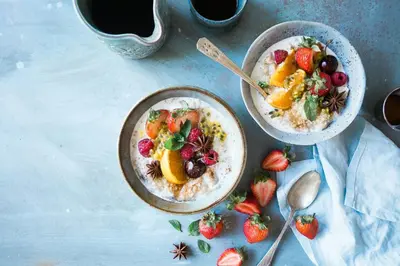 two bowls of oatmeal with fruit and strawberries on a table at The Westin Cincinnati in Cincinnati