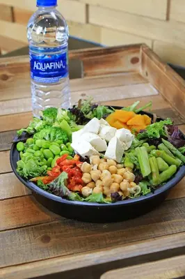 a plate of vegetables on a table with a bottle of water at The Westin Cincinnati in Cincinnati