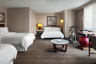 a hotel room with two beds and a table at The Westin Cincinnati in Cincinnati