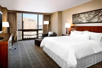 a hotel room with a large bed and a television at The Westin Cincinnati in Cincinnati