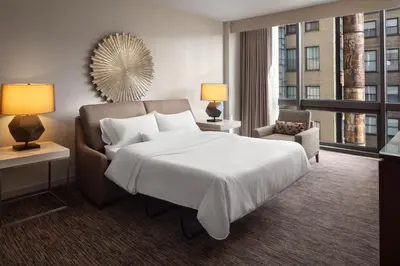 a hotel room with a bed and a large window at The Westin Cincinnati in Cincinnati