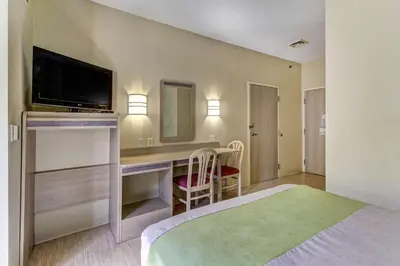 a hotel room with a bed and a desk with a television at Motel 6-Medina, OH - Cleveland in Medina