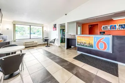 a large lobby with a table and chairs at Motel 6-Mansfield, OH in Mansfield