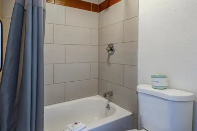 a bathroom with a tub and a toilet and a shower at Days Inn by Wyndham Cincinnati I-71 in Cincinnati