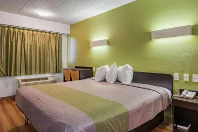 a room with a large bed in a hotel room at Days Inn by Wyndham Cincinnati I-71 in Cincinnati