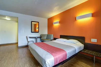 a hotel room with a large bed and a table at Motel 6-Richfield, OH in Richfield