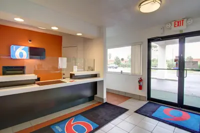a kitchen with orange walls and a large window at Motel 6-Richfield, OH in Richfield