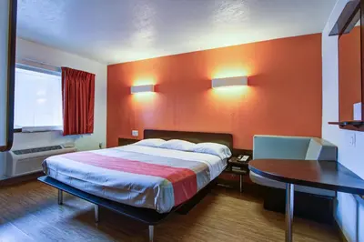 a hotel room with a large bed and a table at Motel 6-Richfield, OH in Richfield