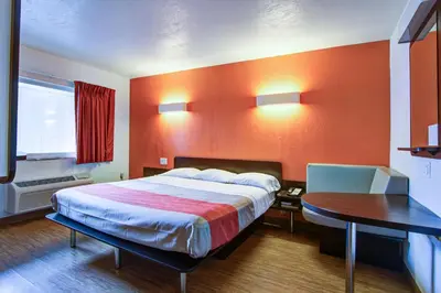 a hotel room with a large bed and a table at Motel 6-Richfield, OH in Richfield