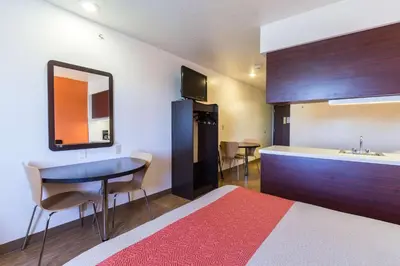 a room with a bed and a kitchen with a sink at Motel 6-Huron, OH - Sandusky in Huron