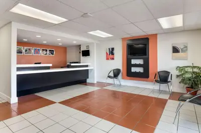 an office lobby with chairs and a reception desk at Motel 6-Youngstown, OH in Youngstown