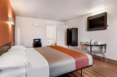 a hotel room with a bed and a tv at Motel 6-Youngstown, OH in Youngstown
