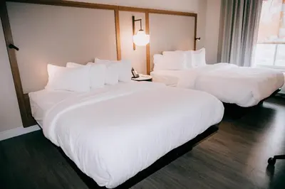 two beds in a hotel room with white sheets at Fairfield by Marriott Inn & Suites Georgetown Lexington in Georgetown