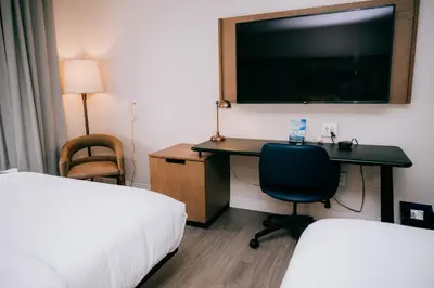a hotel room with a desk and a tv at Fairfield by Marriott Inn & Suites Georgetown Lexington in Georgetown
