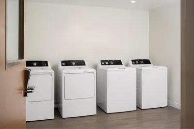 a group of four washers and dryers in a room at Fairfield by Marriott Inn & Suites Georgetown Lexington in Georgetown