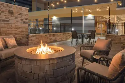a fire pit in a lobby with chairs and a table at Fairfield by Marriott Inn & Suites Georgetown Lexington in Georgetown