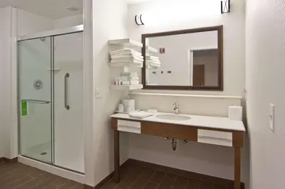 a bathroom with a sink and a shower with a mirror at Hampton Inn & Suites Chillicothe in Chillicothe