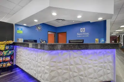 a supermarket checkout counter with a blue wall at SureStay by Best Western Greenville in Greenville