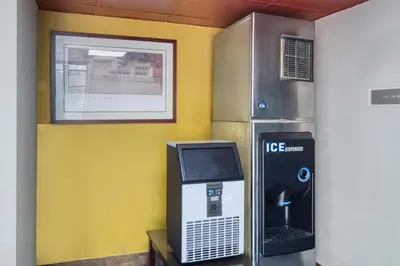 a ice machine next to a atm machine at SureStay by Best Western Greenville in Greenville