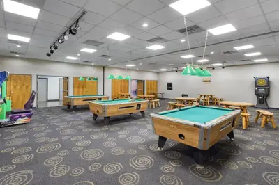 a room with pool tables and ping pong balls at SureStay by Best Western Greenville in Greenville