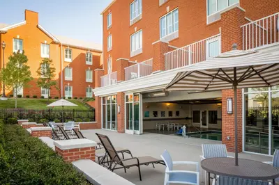 a patio with chairs and tables in front of a building at The Ohioan Hotel and Event Center in Lewis Center