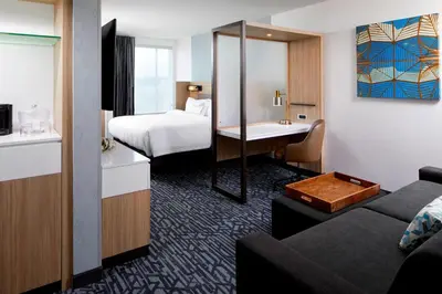a small hotel room with a bed and a couch at SpringHill Suites by Marriott Columbus Easton Area in Columbus