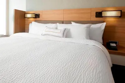 a white bed with a book on top of it at SpringHill Suites by Marriott Columbus Easton Area in Columbus