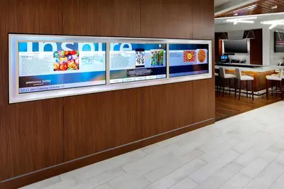 a lobby with a large tv on a wall at SpringHill Suites by Marriott Columbus Easton Area in Columbus