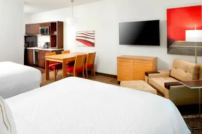 a hotel room with a bed and a dining room at TownePlace Suites by Marriott Columbus Easton Area in Columbus