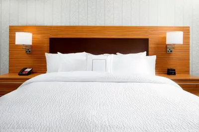 a bedroom with a large white bed with two lamps at TownePlace Suites by Marriott Columbus Easton Area in Columbus