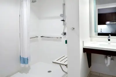 a white bathroom with a shower and a sink at TownePlace Suites by Marriott Columbus Easton Area in Columbus