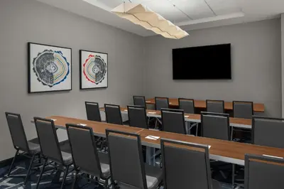a conference room with a large wooden table and chairs at TownePlace Suites by Marriott Columbus Easton Area in Columbus
