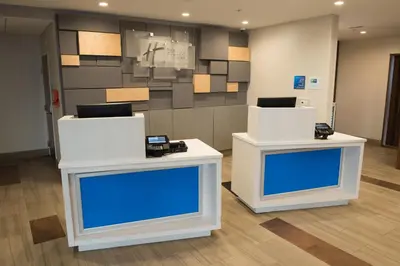 two white tables in a room with blue screens at Holiday Inn Express & Suites - Dayton Southwest by IHG in Dayton