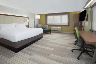 a hotel room with a bed and a desk at Holiday Inn Express & Suites - Dayton Southwest by IHG in Dayton