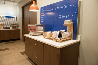 a shop with a counter with a blue wall at Holiday Inn Express & Suites - Dayton Southwest by IHG in Dayton