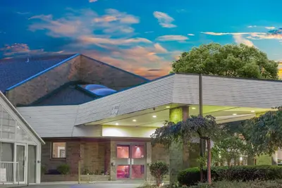 a building with a roof with a sky at Skylight Inn Willoughby - Cleveland Mentor in Willoughby