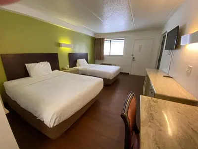 a hotel room with two beds and a kitchen at Skylight Inn Willoughby - Cleveland Mentor in Willoughby