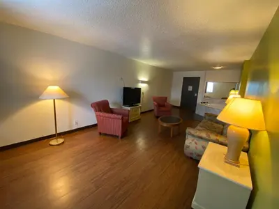 a living room with a couch and chairs and a television at Skylight Inn Willoughby - Cleveland Mentor in Willoughby