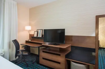 a hotel room with a desk with a television at Fairfield by Marriott Inn & Suites Dayton Downtown in Dayton