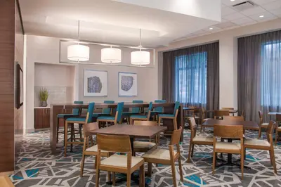 a conference room with tables and chairs and windows at Fairfield by Marriott Inn & Suites Dayton Downtown in Dayton