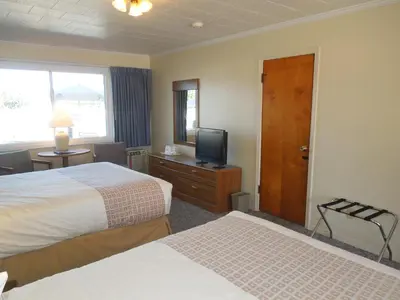 a hotel room with two beds and a television at Arlington Inn in Port Clinton